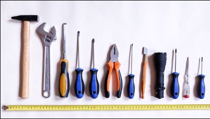 A row of engineering hand tools on a white background.